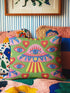 Square weirdcore throw pillow cover printed to look like textured crewel embroidery on a green background. A pink and blue flying saucer with one large blue eye at its center hovers among floating blue eyeballs and red hearts. Smooth flat 2D print, not raised stitching. Maximalist, trippy sci-fi dopamine decor with quirky alien charm for a sofa, dorm bed, gaming chair, or reading nook, made for space lovers and sci-fi fans.