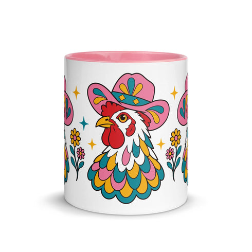 Glossy white ceramic coffee mug with a colored rim, inside, and handle and a full wraparound folk art print. Chickens wear pink cowboy hats with teal bands, yellow diamonds, flowers, and teardrop motifs. The birds have white heads, red combs and wattles, and layered pink, teal, and golden yellow feathers outlined in black. Pink and yellow flowers, teal leaves, and four-point starbursts fill the space between. Retro western kitchen decor.