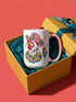 Glossy white ceramic coffee mug with a colored rim, inside, and handle and a full wraparound folk art print. Chickens wear pink cowboy hats with teal bands, yellow diamonds, flowers, and teardrop motifs. The birds have white heads, red combs and wattles, and layered pink, teal, and golden yellow feathers outlined in black. Pink and yellow flowers, teal leaves, and four-point starbursts fill the space between. Retro western kitchen decor.