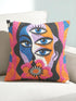 Square psychedelic throw pillow cover with a surreal weirdcore face printed to look like textured crewel embroidery. The face has a third eye and extra blue eyes, long dark hair, and a large pink and orange flower over the mouth, framed by radiating wavy stripes in hot pink, orange, and cobalt blue with black and white checkerboard corners. Smooth flat 2D print, not raised stitching. Maximalist 70s trippy decor for a sofa, armchair, or dorm bed.