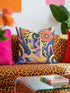 Square eclectic throw pillow cover with a surreal modern art portrait printed to look like textured crewel embroidery on a cobalt blue background. A yellow and purple half face with red lips holds a yellow crescent moon and a pink and purple staircase inside its dark silhouette, with a large orange flower in wavy yellow hair and abstract pink and yellow shapes around it. Smooth flat 2D print, not raised stitching. Maximalist art decor for a sofa, studio chair, or dorm.