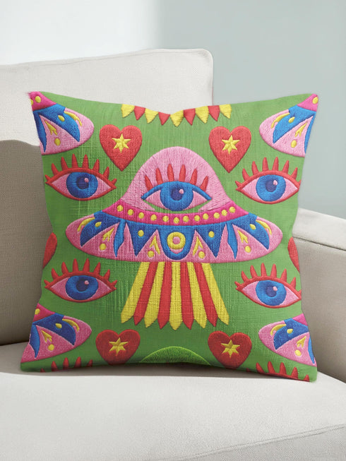 Square weirdcore throw pillow cover printed to look like textured crewel embroidery on a green background. A pink and blue flying saucer with one large blue eye at its center hovers among floating blue eyeballs and red hearts. Smooth flat 2D print, not raised stitching. Maximalist, trippy sci-fi dopamine decor with quirky alien charm for a sofa, dorm bed, gaming chair, or reading nook, made for space lovers and sci-fi fans.