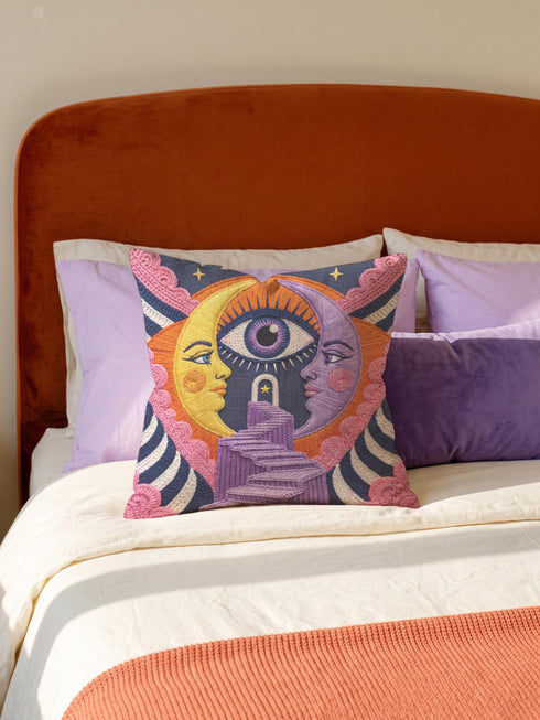 Square celestial throw pillow cover printed to look like heavy satin-stitch embroidery. A glowing yellow crescent sun and a lavender purple moon face a cosmic third eye, above a winding purple staircase that climbs to a starry archway framed by pink clouds and rayed sunbursts. Smooth flat 2D print, not raised stitching. Mystical, witchy, boho maximalist decor for a sofa, bed, reading nook, or altar corner, made for astrology lovers and tarot readers.