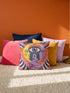 Square celestial throw pillow cover printed to look like heavy satin-stitch embroidery. A glowing yellow crescent sun and a lavender purple moon face a cosmic third eye, above a winding purple staircase that climbs to a starry archway framed by pink clouds and rayed sunbursts. Smooth flat 2D print, not raised stitching. Mystical, witchy, boho maximalist decor for a sofa, bed, reading nook, or altar corner, made for astrology lovers and tarot readers.