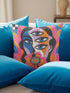 Square psychedelic throw pillow cover with a surreal weirdcore face printed to look like textured crewel embroidery. The face has a third eye and extra blue eyes, long dark hair, and a large pink and orange flower over the mouth, framed by radiating wavy stripes in hot pink, orange, and cobalt blue with black and white checkerboard corners. Smooth flat 2D print, not raised stitching. Maximalist 70s trippy decor for a sofa, armchair, or dorm bed.