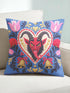 Square gothic Christmas throw pillow cover in a folk art design printed to look like textured crewel embroidery on a medium blue background. A red horned Krampus face with a long tongue sits inside a white and gold scalloped heart, surrounded by dark leafy vines, pink tulips, red carnations, gold bells tied with red bows, and small gold stars. Smooth flat 2D print, not raised stitching. Maximalist spooky holiday decor for a sofa, armchair, or goth bedroom.