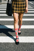 Pair of crew length socks with an all-over folk art print on a cream background. Red anatomical hearts stack vertically between symmetrical floral sprays with fine cream vessel lines, curling green stems and leaves, red flowers, purple tulip-shaped blooms, and small yellow accents. Red cuffs carry cream scrolling vines and small hearts above a scalloped border. Reinforced black heel and toe, striped ribbed cuff. Maximalist medical gift socks.