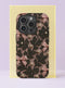 Front view of a dual layer tough phone case printed edge to edge with a coquette lace design. Black floral lace vines climb over a blush nude background, decorated with little pink satin bows and scattered cream pearls, all rendered as a realistic flat print. It looks like vintage lingerie and a jewelry box had a very pretty argument. Dark coquette lace and pearls phone accessory with open ports and a precise camera cutout.