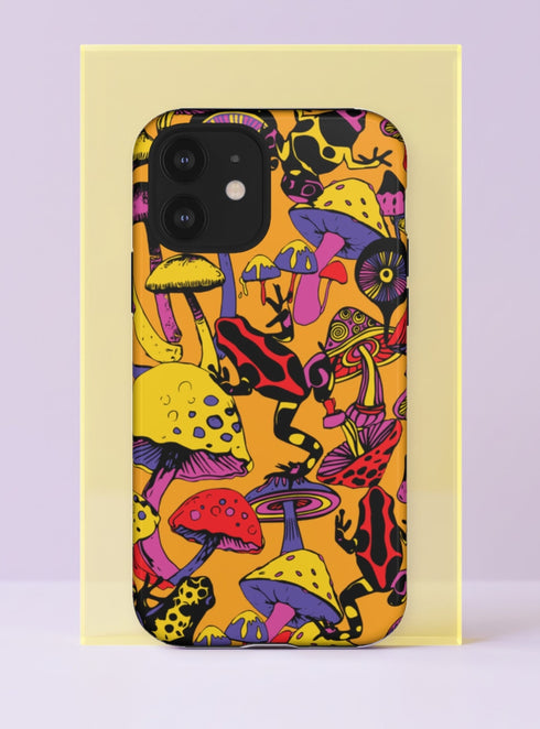 Front view of a dual layer tough phone case printed edge to edge with psychedelic magic mushrooms and poison dart frogs on a warm tangerine orange background. Yellow, red, lavender, and pink mushrooms with polka dot and spiral caps pile up across the case, while black frogs striped in red and yellow crawl between the stems. Bold black outlines give it a vintage comic book punch. Trippy 70s retro mushroom phone accessory with open ports and a precise camera cutout.