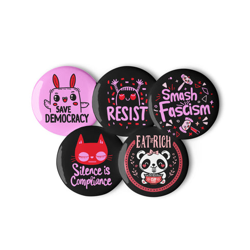 \A set of five glossy round pinback buttons with pastel goth and kawaii punk designs, featuring slogans like "Eat The Rich" and "Smash Fascism" in bold pink and black. Each pin has a cute character delivering a powerful message.