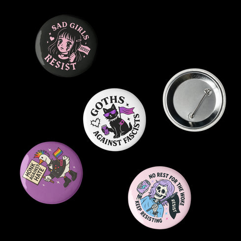 Set of 5 anti-fascist resistance pinback buttons featuring "Sad Girls Resist," "Goths Against Fascists," "Existential Dread Club," "Honk Against Hate," and "No Rest for the Woke" designs. Each pin measures 2.25" diameter. Made with durable tinplate and scratch-resistant mylar coating. Perfect protest accessories for activists, anti-fascist supporters, and LGBTQ+ allies. Express your resistance with these statement pins.