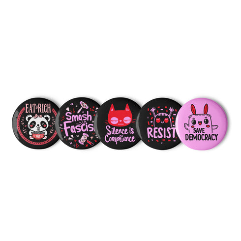 A set of five glossy round pinback buttons with pastel goth and kawaii punk designs, featuring slogans like "Eat The Rich" and "Smash Fascism" in bold pink and black. Each pin has a cute character delivering a powerful message.