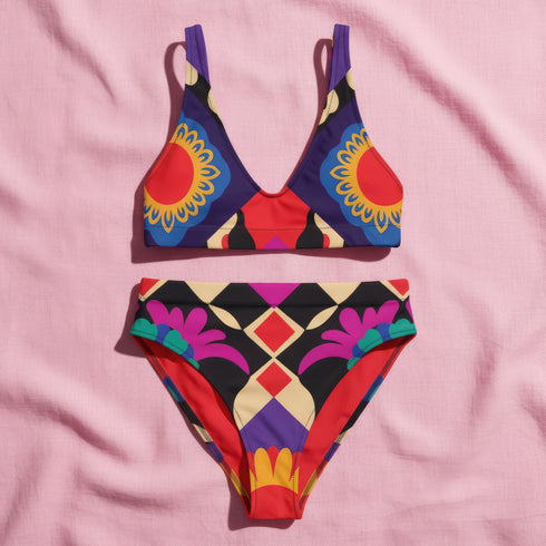 Two piece high waisted bikini in a bold 70s psychedelic geometric print. The sporty scoop top features bright yellow and red sunbursts over a black, purple, cream, and red colorblock background. The high cut bottoms carry matching geometric diamonds with hot pink and teal abstract palm leaves. Smooth form fitting recycled polyester fabric with UPF 50 sun protection and removable padding. Vibrant maximalist retro swimwear in saturated primary and secondary shades, made for pool parties, festivals, and loud s