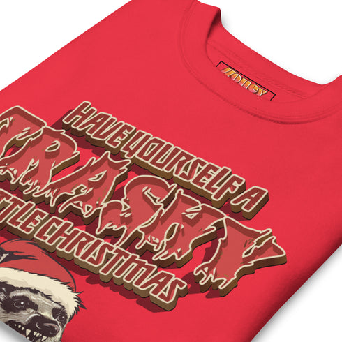 Holiday jumper sweatshirt with "HAVE YOURSELF A TRASHY LITTLE CHRISTMAS" text above a possum wearing a Santa hat, peeking out of a garbage can. Bold, punk-style lettering in red and yellow.