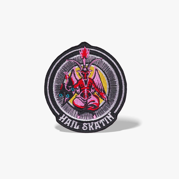 Patch featuring a red goat-headed figure with wings and a flaming torch, holding a pair of roller skates, surrounded by a circular design with the text 'Hail Skatin'. The design is bold and edgy, blending skate culture with a mystical motif.