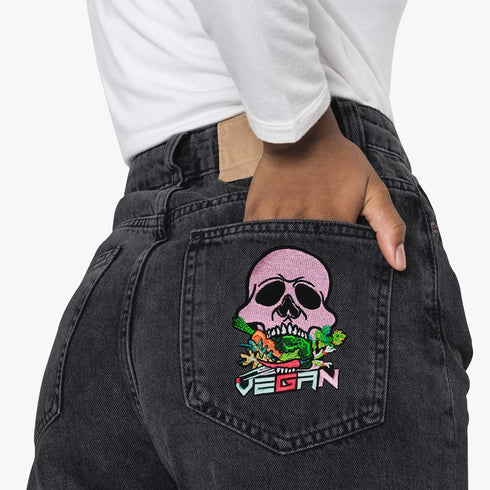 Patch featuring a pink skull biting into colorful vegetables with the word 'VEGAN' in bold letters below, set against a black background. The design is vibrant and edgy, blending vegan pride with a punk rock aesthetic.