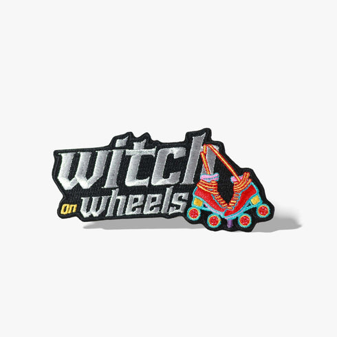 Patch with the text 'Witch on Wheels' featuring roller skates with witch's legs, set against a vibrant red background. The design combines playful witchcraft elements with a fun, retro skating theme.