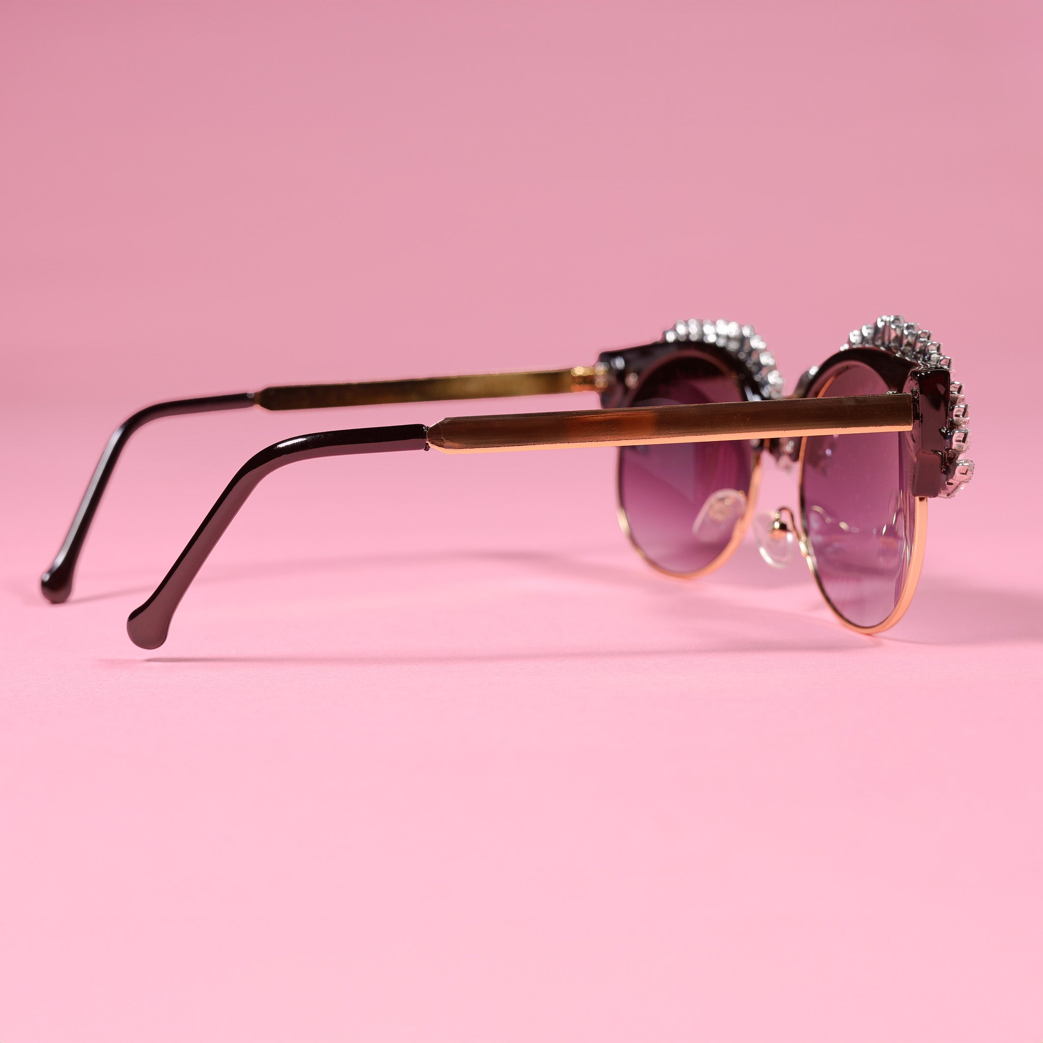 a pair of sunglasses on a pink background