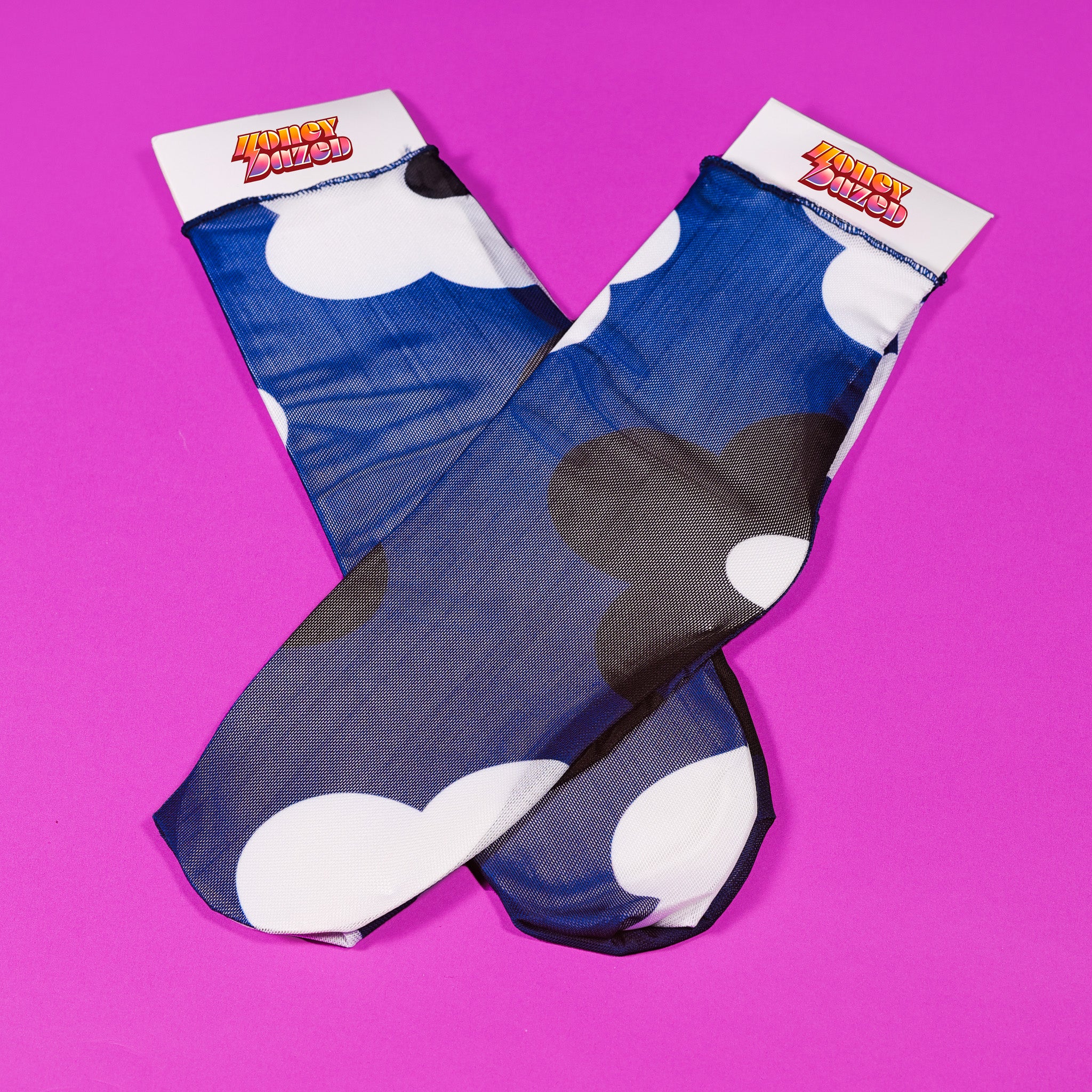 a pair of blue and white socks on a pink background