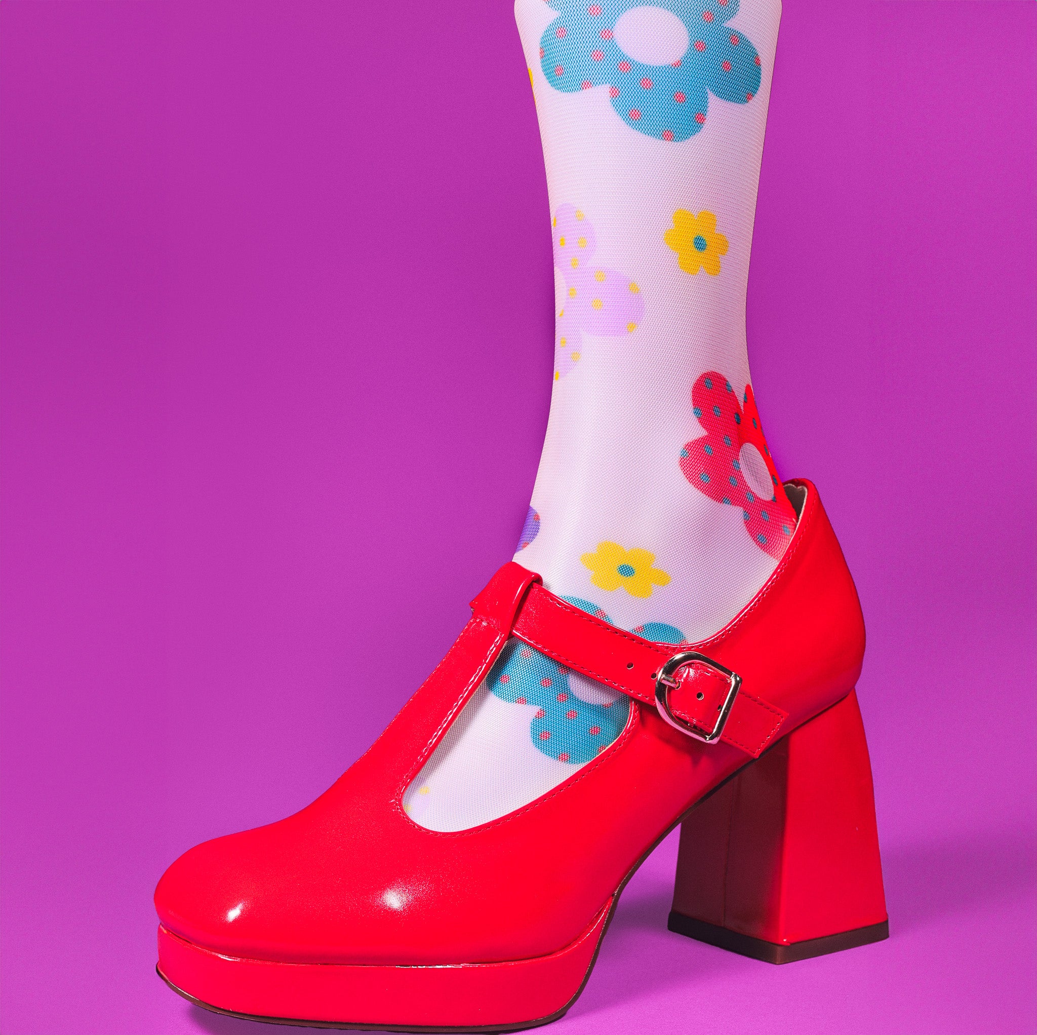 a pair of red shoes with flowers on them