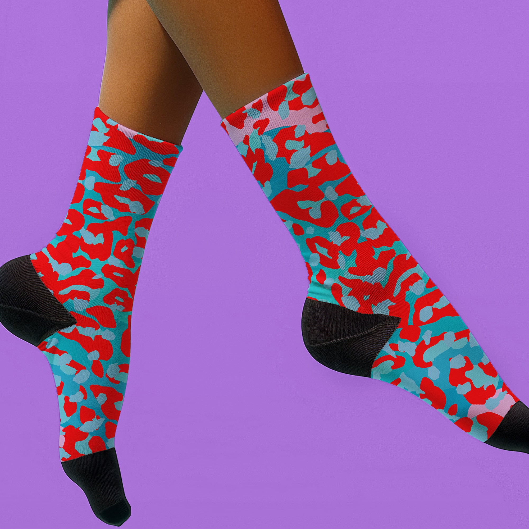 Dive into bold fashion with these vibrant socks featuring an eye-catching red, blue, and pink cheetah print pattern. Perfect for those who love to make a statement, these socks are ideal for brightening up any outfit and showcasing your unique style. Comfortable and stylish with black heels and toes, they are a must-have accessory for the fashion-forward.