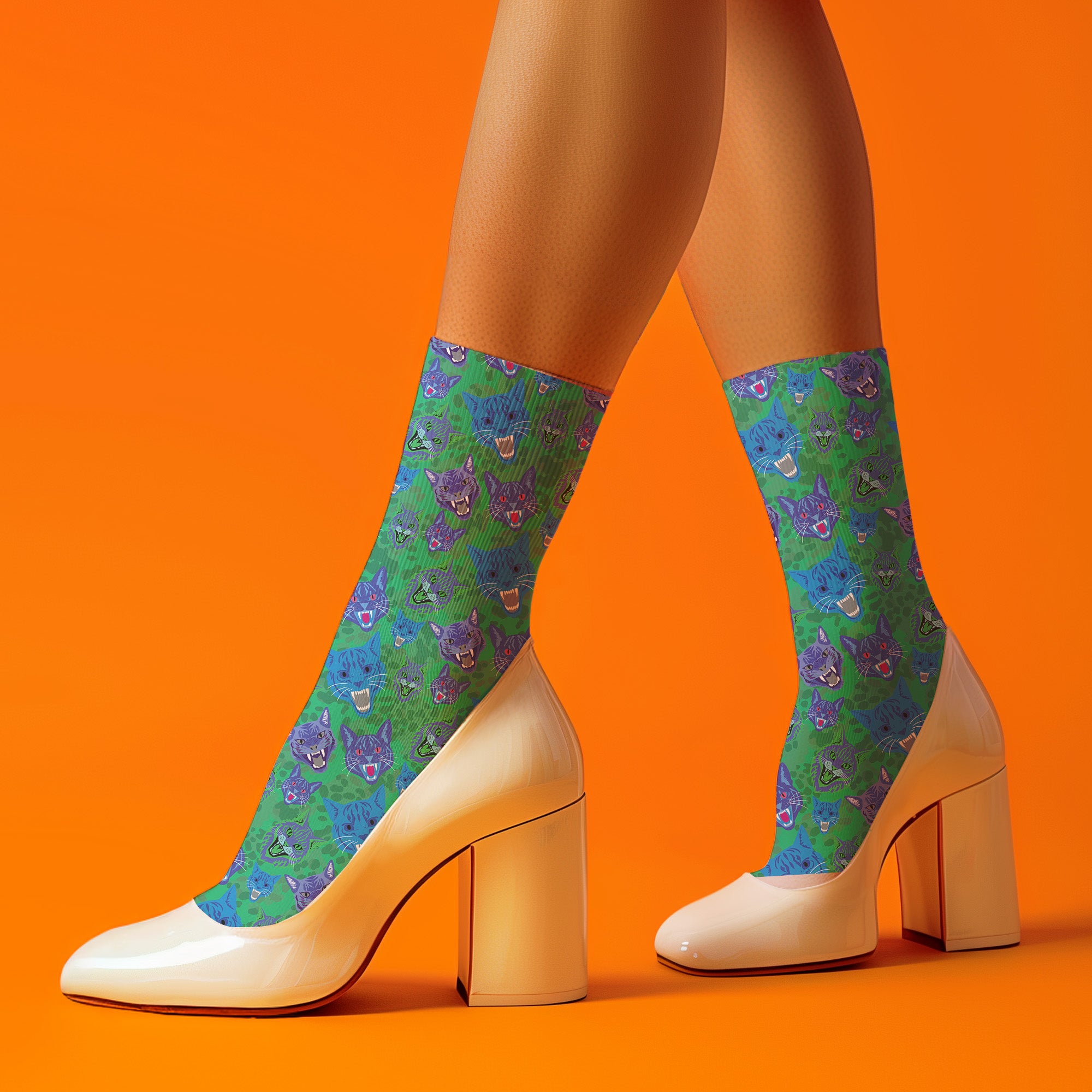 Fun and playful socks adorned with vibrant tiger head motifs on a green background, with black heels and toes, ideal for animal lovers and those who enjoy unique designs