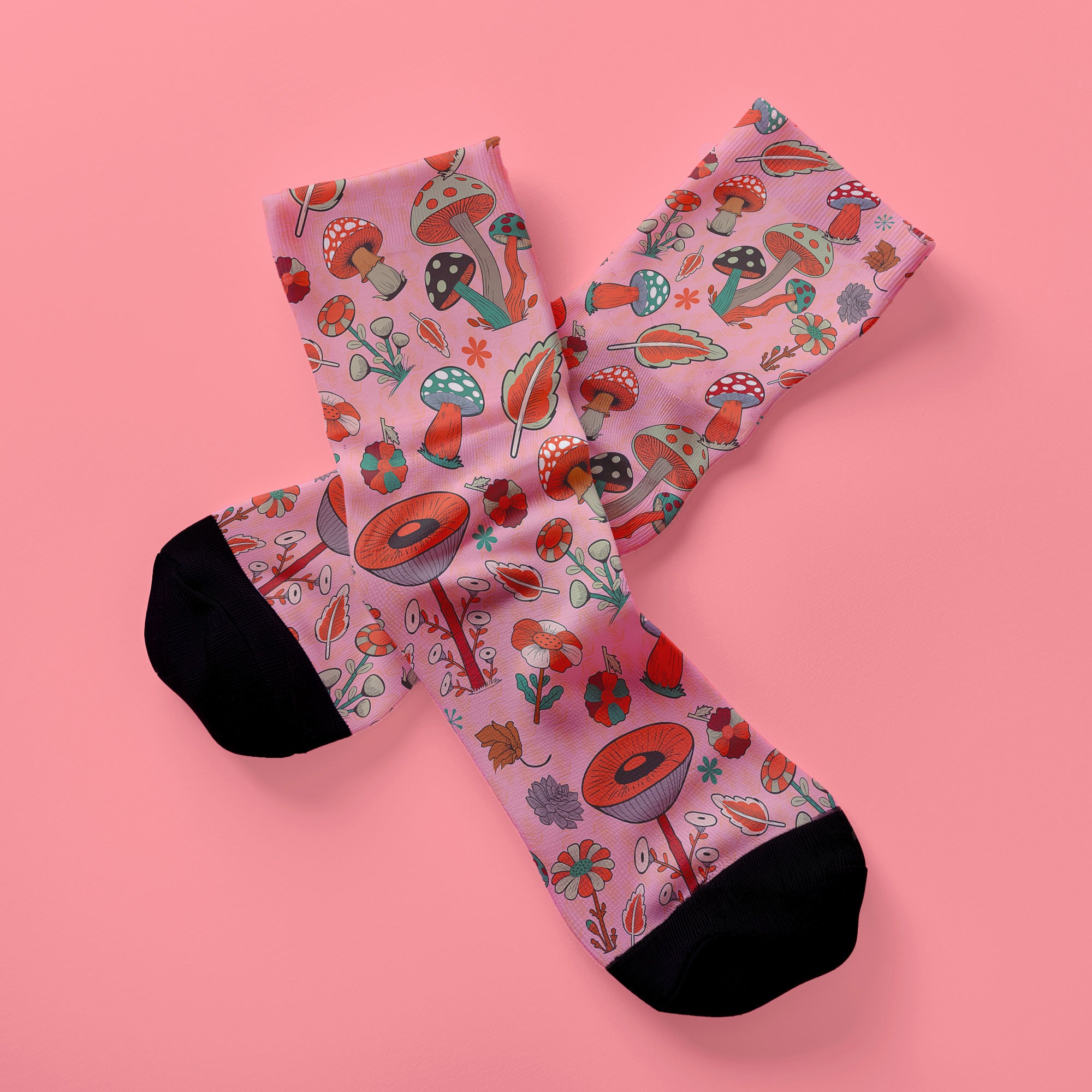 Cute mushroom-themed pink socks with various fungi and nature illustrations, black heels and toes, ideal for casual wear or gifting