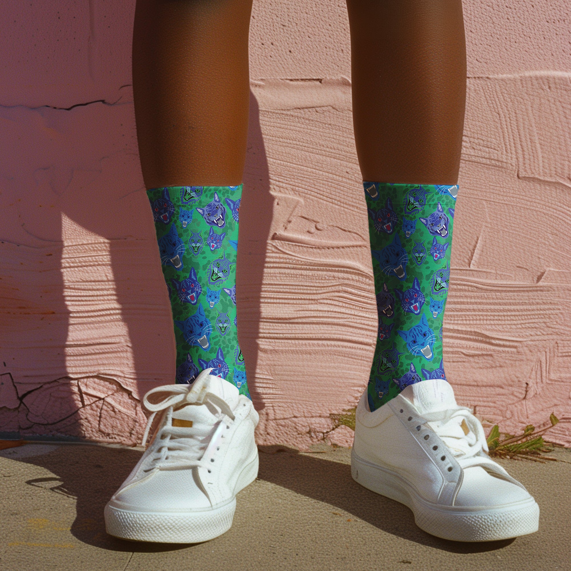 un and playful socks adorned with vibrant tiger head motifs on a green background, with black heels and toes, ideal for animal lovers and those who enjoy unique designs