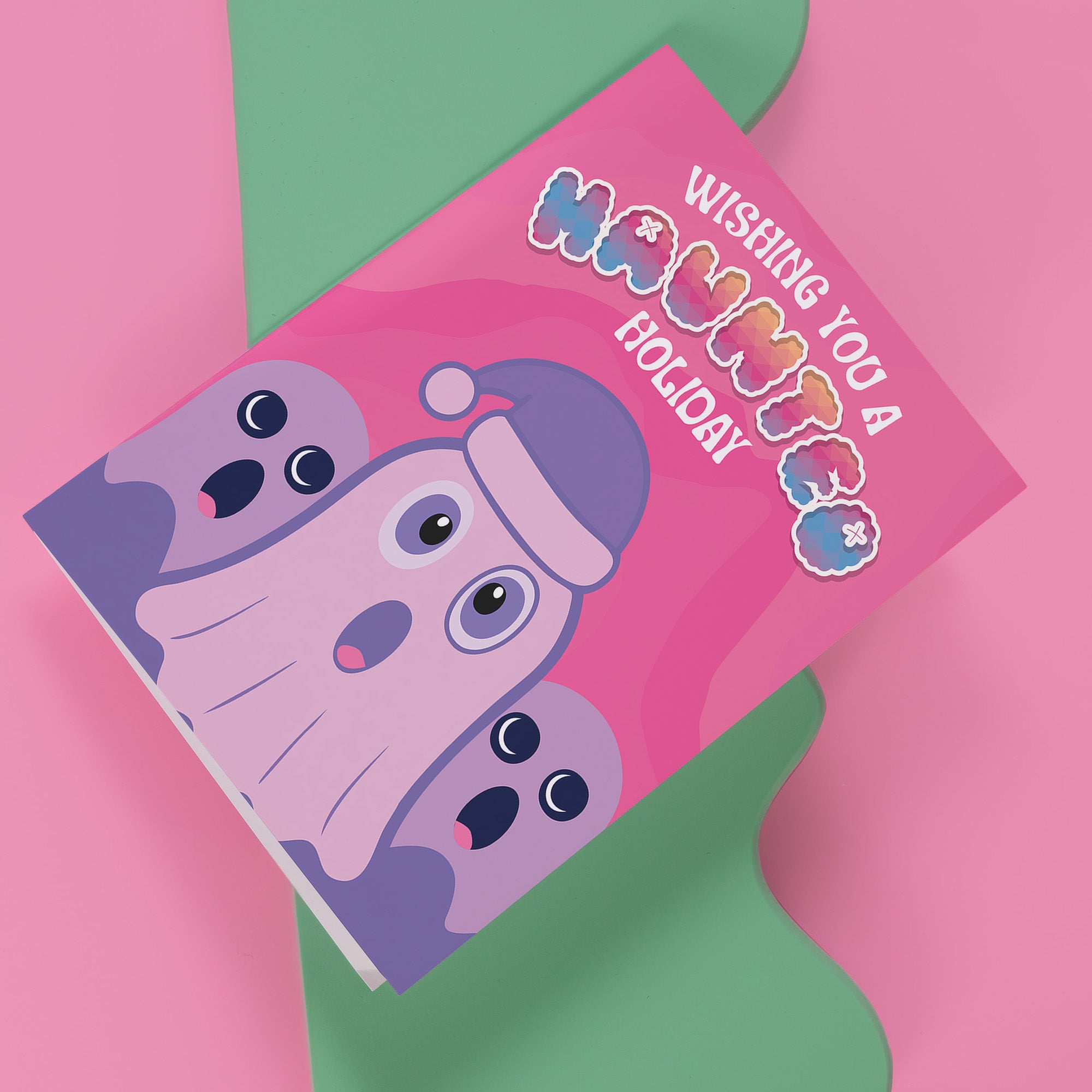 Holiday card with pink background featuring cartoon ghosts. Main ghost wears purple Santa hat. Text reads 