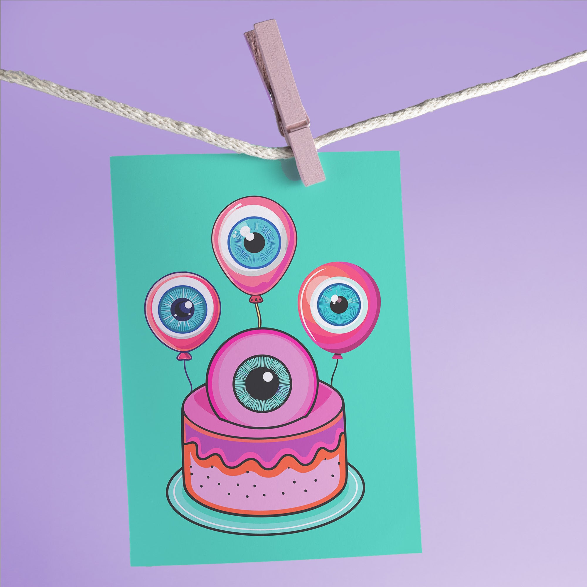 Quirky birthday card illustration on teal background. Pink cake with large eyeball on top. Three eyeball balloons float above the cake. Each eyeball has a blue iris with pink outer ring. Inside message: 