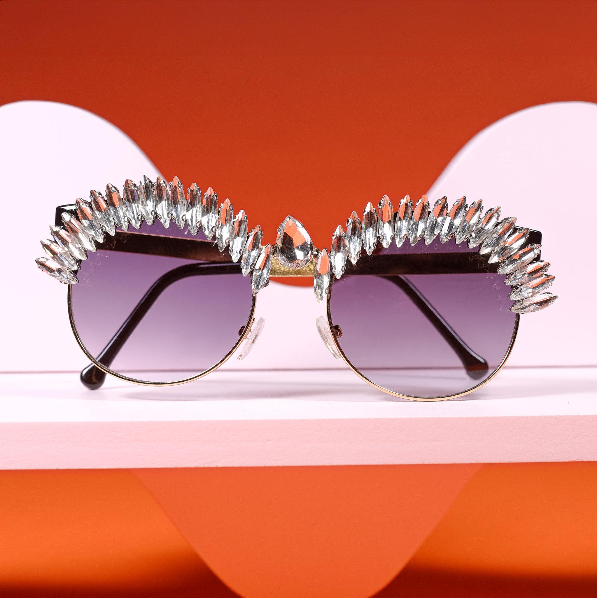a pair of sunglasses sitting on top of a shelf