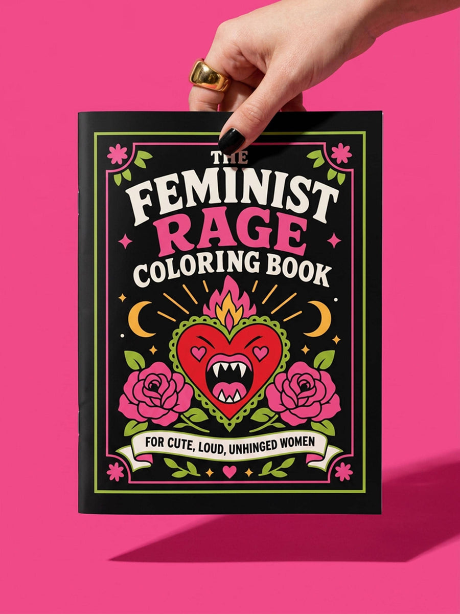 A 8.5 by 11 inch softcover coloring book titled The Feminist Rage Coloring Book For Cute Loud Unhinged Women. The black cover features vibrant pink and green typography, a fanged heart engulfed in flames, pink roses, and crescent moons. The back cover displays a heart pierced by a dagger and text reading Your feelings are valid your rage is too. Inside pages contain black and white line art with bold feminist quotes, floral borders, potions, coffins, and edgy witchy illustrations.
