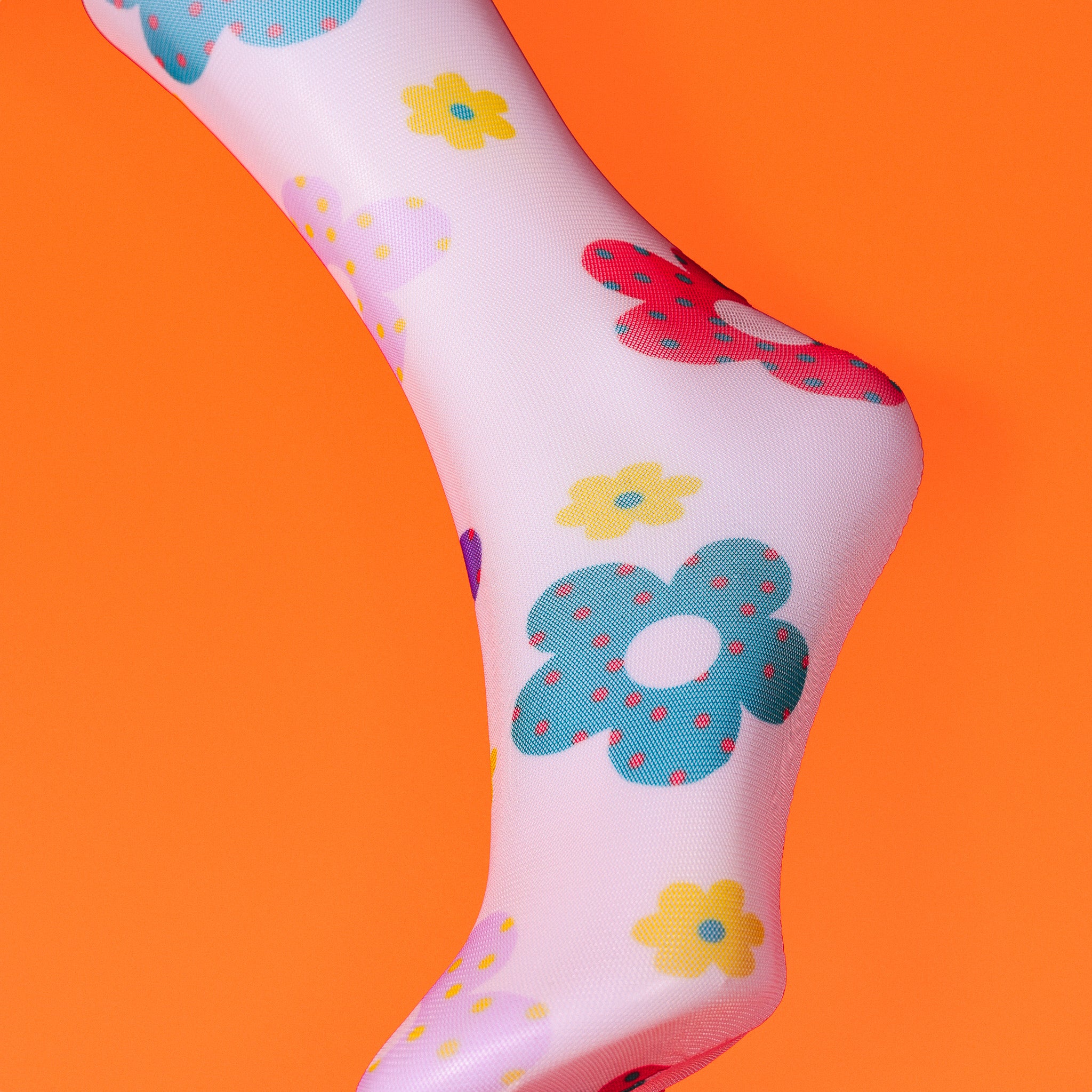a close up of a foot with flowers on it