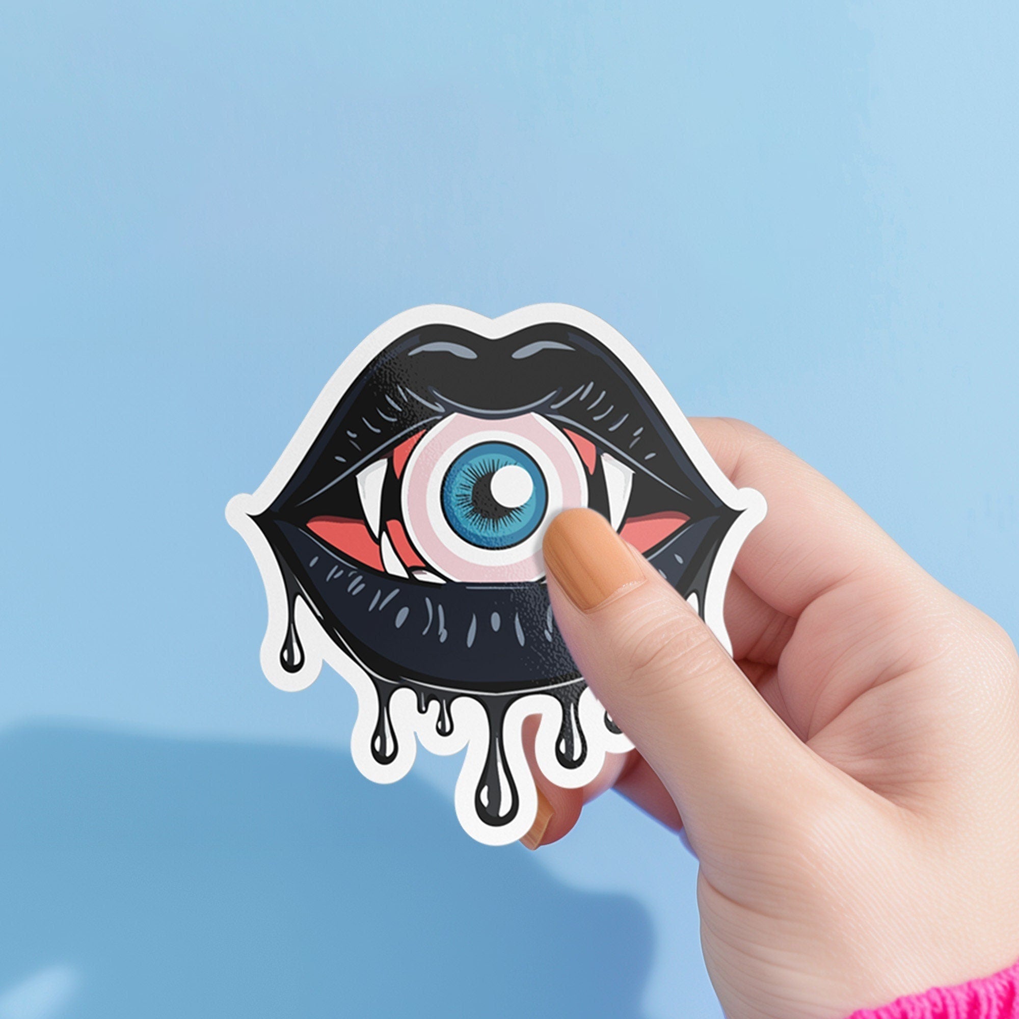 Eyeball vampire fangs sticker with black lips, perfect for adding a spooky touch to laptops, phones, and water bottles. Available in Prism, Gem, and Glitter finishes. Handmade in Austin, Texas.