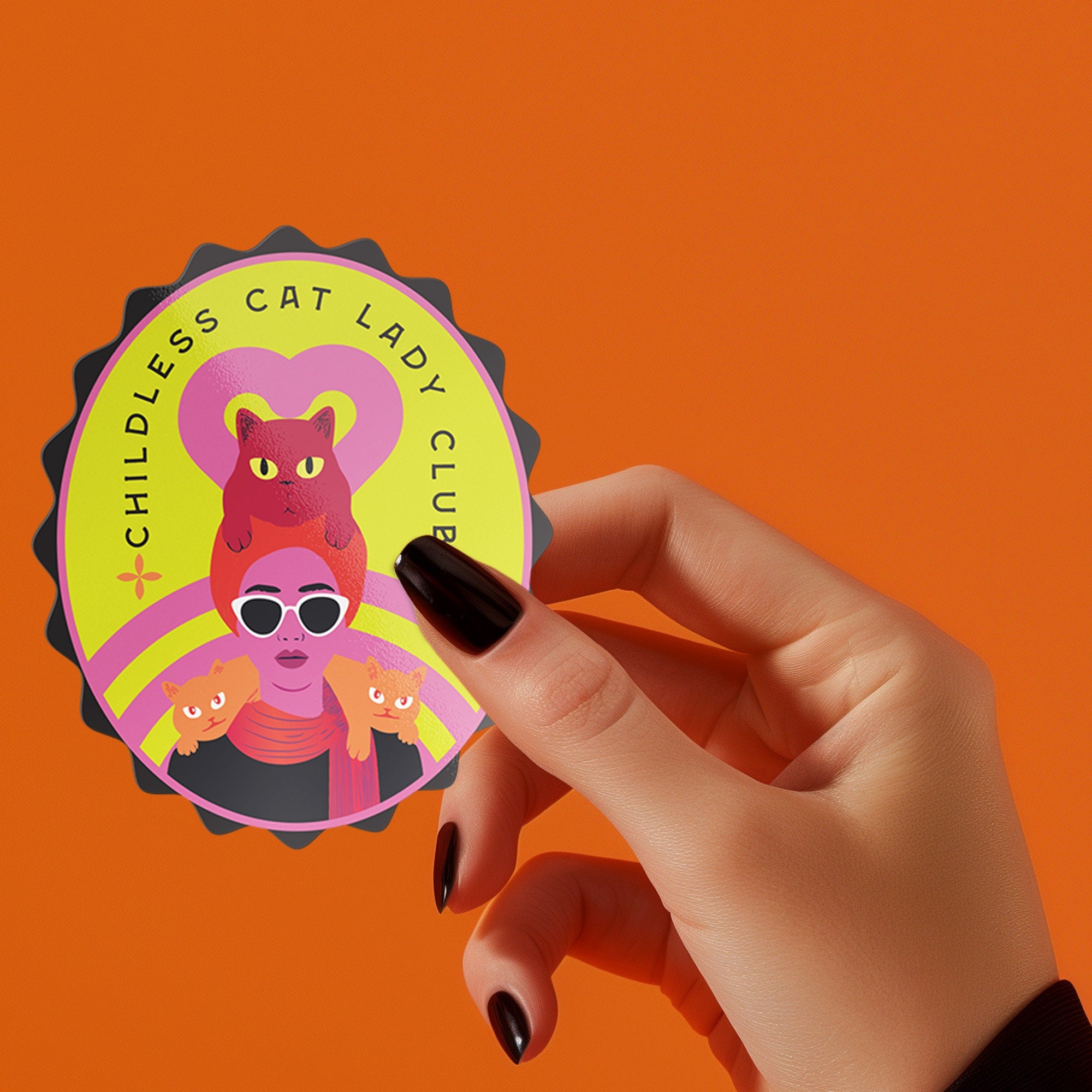 Vibrant oval sticker reading "Childless Cat Lady Club". Features cartoon woman with sunglasses surrounded by cats. Bold retro design in pink, yellow, and red.